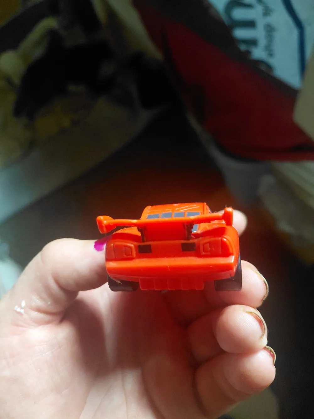 red Disney Pixar Lightning McQueen toy car, appearing to be a plastic model.